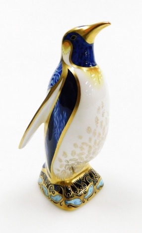 A Royal Crown Derby porcelain Emperor Penguin paperweight, gold stopper and red printed marks, 14cm high, boxed.