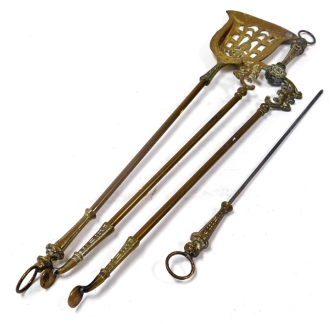 A set of late 19th brass fireside implements, to include a shovel with pierced plate, tongs and a poker, the shovel 81cm long.