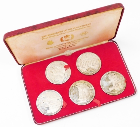 A Tower Mint Silver Jubilee medallion set, of five coins, Department of the Environment, showing Kensington Palace, Caernarfon Castle, Holyrood House, Hampton Court Palace, and Osborne House, boxed with certificate, 7.32oz.