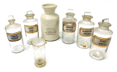 Five vintage glass pharmacist jars, with stoppers, for Bulve; Amyli, tinct; Rhei.co, Bismark Brown, Ammon; Bromid, and Pulv; Rhei, together with a half pint measuring jug and a pottery neuralgic anodyne jar, The Apothecary Store, Bedford, PA, 27cm high. (