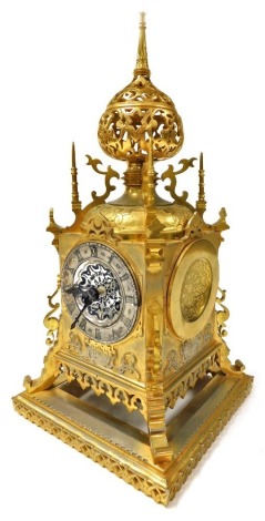 A late 19thC French brass mantel clock, by Vincent & Cie, for Aubert and Company, circular silvered dial with chapter ring bearing Roman numerals, eight day movement with bell strike, the case of gothic form with a minaret top, raised on an integral recta