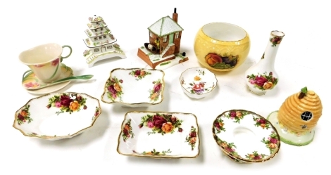 A group of porcelain, including two Coalport models of the Pagoda House and The Fishermans Cottage, an Aynsley Orchard Gold pot pourri bowl, Franz Porcelain cup, saucer and spoon, Coalport Beehive Cottage, and Royal Albert dishes and ornaments decorated i