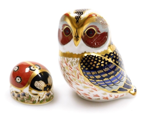 A Royal Crown Derby imari paperweight modelled as a tawny owl, together with another modelled as a ladybird, seconds. (2)