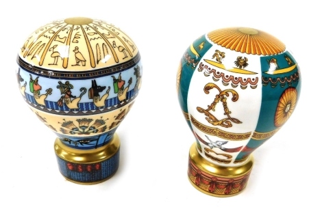 A pair of Royal Worcester porcelain candle snuffers modelled as hot air balloons, comprising Up, Up and Away, Zodiac, limited edition 89/500, and Egypt, limited edition 89/500. (2)