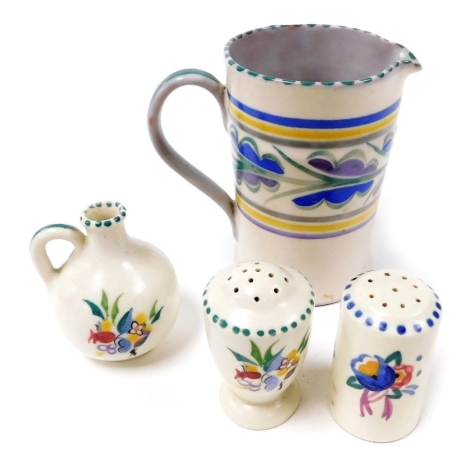 A Carter Stabler Adams Poole pottery jug, decorated with a band of stylized leaves, two Poole pottery pepperettes, and a miniature flagon, traditionally painted with flowers. (4)