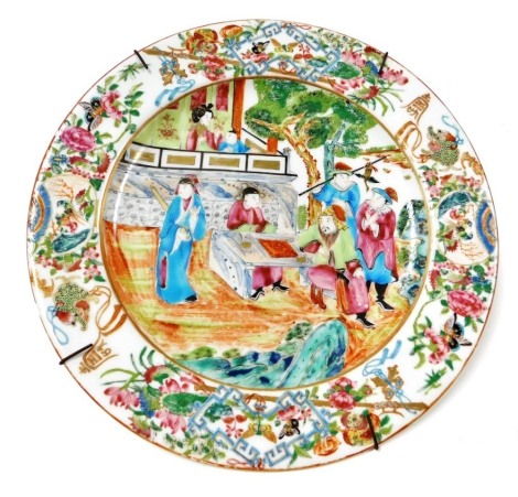 A mid 19thC Worcester Vitreous porcelain chinoiserie plate, famille rose decorated with figures in a garden, within a border of Buddhist emblems, birds, butterflies and flowers, impressed mark, 26.5cm wide.