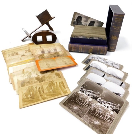 A Stereoscopic viewer and cards, including European and American views, together with a Realistic Travel Views Series of stereoscopic cards of World War I, contained in a faux two volume book box.