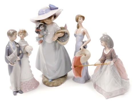 A Lladro porcelain figure of a lady with a parasol, figure group of a bride and bridegroom, and a girl with a bonnet, together with a Nao porcelain figure of a girl with a doll and basket. (4, AF)