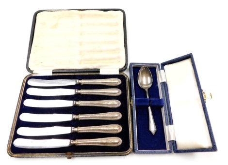 A set of six George V silver handled cake knives, cased, Sheffield 1919, and a silver Christening spoon, cased, Sheffield 1959.