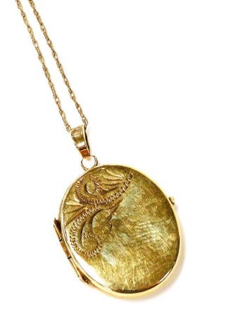 A 9ct gold locket, with engraved decoration and chain, 2.9g all in.