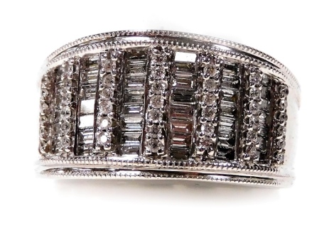 An Iliana 18ct white gold and diamond ring, pave set with twelve rows of alternating baguette and brilliant cut diamonds, size T, 10.2g.all in.