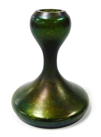 A Loetz style iridescent green glass vase, of waisted form, raised on a spread circular foot, 14cm high.