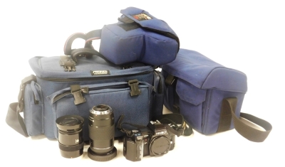 A Minolta 7000 camera, cased, together with lenses.