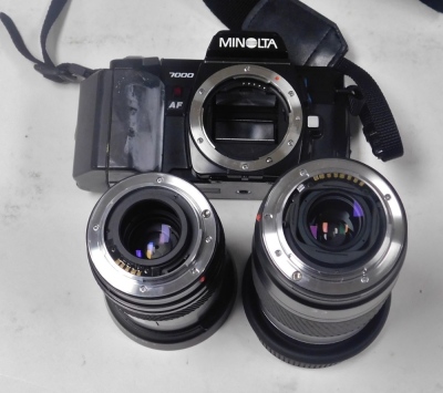 A Minolta 7000 camera, cased, together with lenses. - 2