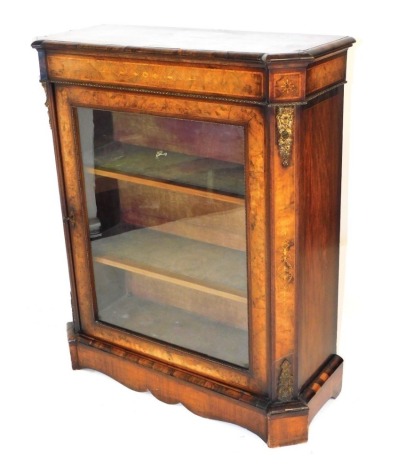 A Victorian walnut and satinwood inlaid pier cabinet, with gilt brass mounts, the glazed door enclosing two shelves, raised on a plinth base, 108cm high, 87cm wide, 36cm deep.