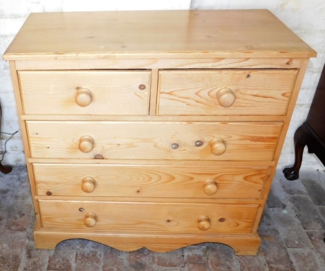 A pine chest of drawers, the top with a moulded edge above two short and three long drawers, raised on bracket feet, 87cm wide.