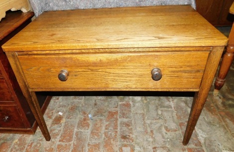 An oak side table, the rectangular top with rounded corners, above a deep frieze fall, raised on square tapering legs, 74cm high, 102cm wide.