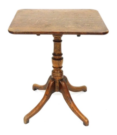 A George III oak tilt top occasional table, the rectangular top raised on a baluster turned column over four cabriole legs, 71cm high, 60.5cm wide, 52.5cm deep.