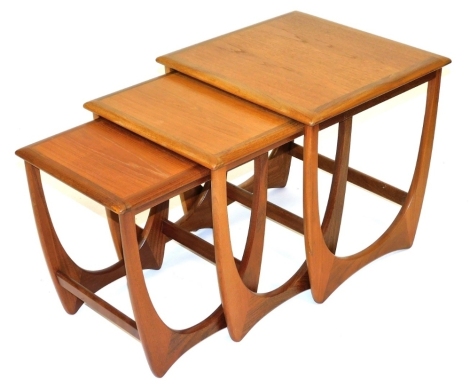 A G-Plan teak nest of occasional tables, raised on U shaped supports, the largest 51cm high, 51cm wide, 49cm deep.