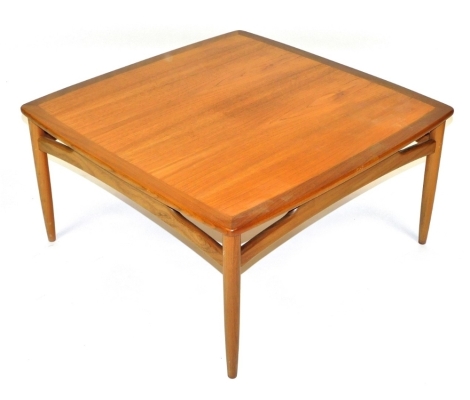 A G-Plan teak coffee table, of square form, raised on turned tapering legs, 43cm high, 86cm wide, 86cm deep.