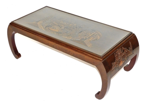 A Chinese hardwood coffee table, of rectangular altar form, the top carved with figures and pagodas in a landscape, raised on curved legs, 35cm high, 100cm wide, 45cm deep.