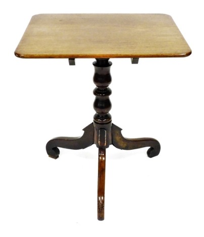 A late Georgian mahogany tilt top occasional table, the rectangular top raised above a baluster turned column over three cabriole legs, 70cm high, 64cm wide, 54cm deep.