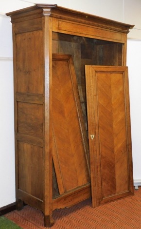 A late 19thC French chestnut armoire, the outswept pediment over a pair of doors enclosing shelves and drawers, raised on turned feet, 226cm high, 162cm wide, 71cm deep.