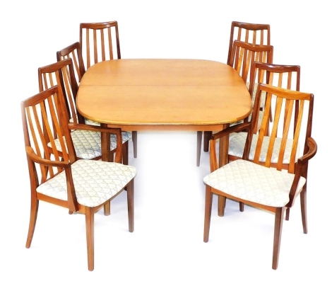 A G-Plan teak dining table and chairs, the oval topped drawer leaf table raised on turned legs, 74cm high, 136cm wide, 185cm extended, 117cm deep, together with eight dining chairs, comprising a pair of carvers and six single chairs. The upholstery in th