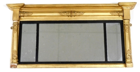 A 19thC giltwood overmantel mirror, with a rococo scroll moulding, inset three panels of rectangular glass, 49cm high, 99cm wide.