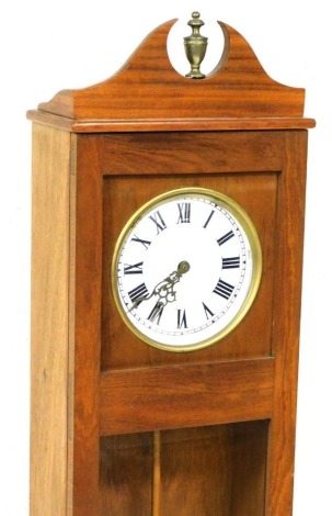 An electric wall clock, the dial with painted Roman numerals, in a teak case, the glazed door enclosing the interior, lacking majority of movement, 152cm high.