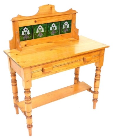 A late Victorian pine wash stand, with tiled splash back and single frieze drawer, raised on turned legs united by stretchers and a plank under tier, 112cm high, 92cm wide, 43.5cm deep.