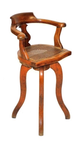 A Victorian mahogany child's high chair, with a inverse heart carved vase splat, and cane seat, raised on four long cabriole legs, 84cm high.