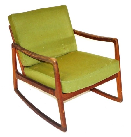 A Danish teak rocking chair, design by Ole Wanscher, for France and Son, with green fabric covered loose cushion seats, 65cm wide.