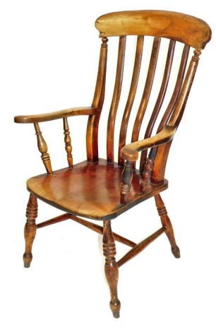 A Victorian oak and beech lath back kitchen chair, with solid saddle seat, raised on ring turned legs, united by an H framed stretcher.