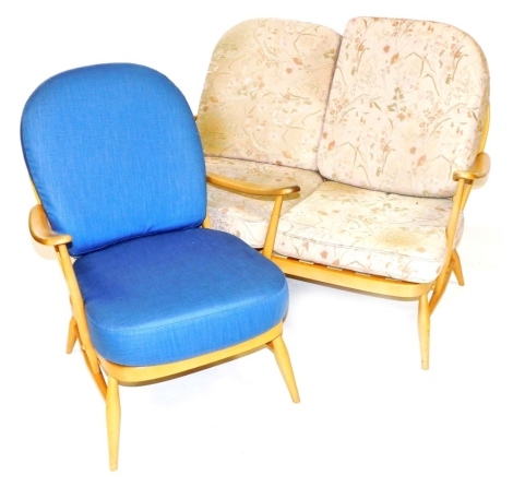 An Ercol light beech and elm two seater sofa, with floral loose cushions, 164cm wide, together with a matching armchair, upholstered in plain blue fabric. The upholstery in this lot does not comply with the 1988 (Fire & Fire Furnishing) Regulations, unles