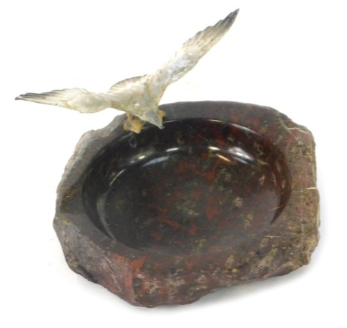 A mid century serpentine ashtray, with applied cold painted metal seagull to rim, 12cm diameter.