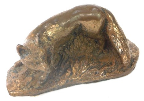 A bronzed metal figure of a fox, on the prowl, with baize lined base, 12cm diameter.