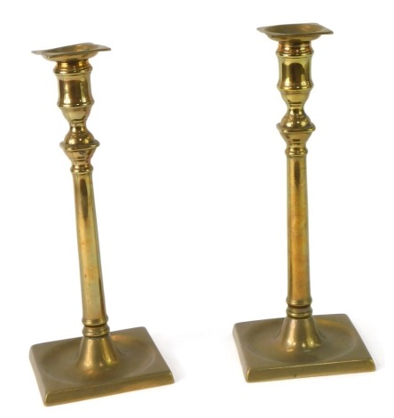 A pair of 19thC tapered stem brass candlesticks, each with a square top and square base, 27cm high. (2)