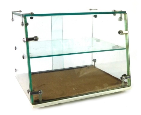 A 1960/1970's tabletop cake display case, with single shelf, on ebonised feet, 24cm high, 30cm wide, 26cm deep.