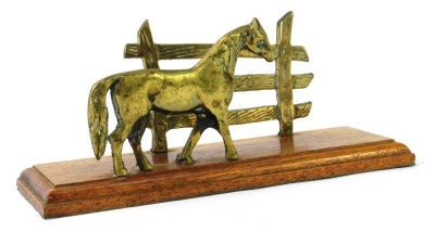 A novelty letter rack, with brass horse and fence post, on a stepped wooden base, 14cm high, 25cm wide, 10cm deep.