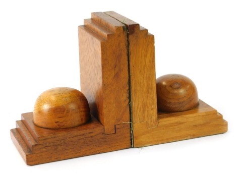 A pair of 1960s/70s carved oak book ends, each with graduated ends, and central dome, 14cm high.