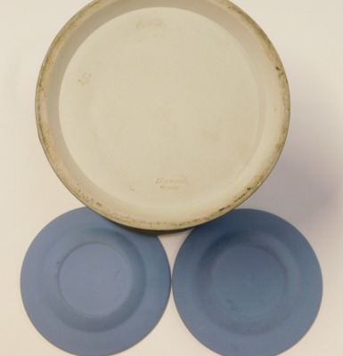 Three items of blue Jasperware, comprising two Wedgwood pin dishes, one with central ram another with two cherubs, 12cm diameter, and a royal blue Tunstall by Adams biscuit barrel, with steel handle and lid, 20cm high. (3) - 2