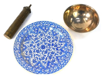 A group of Middle Eastern wares, comprising a silver coloured metal bowl, 19cm diameter, a spit jack, 26cm high, and a cabinet plate of blue and white design, 31cm diameter. (3)