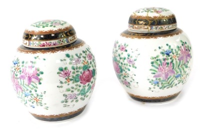 A pair of late 19thC Samson porcelain ginger jars and covers, each with hand painted purple flower decoration, with royal blue border with gilt highlights, 21cm high. (AF)