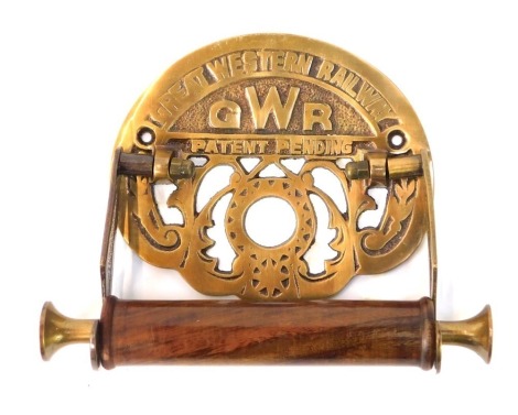 A Great Western Railway toilet roll holder, with brass back plate marked GWR and a turned wooden holder, 19cm diameter.