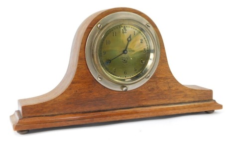 A Smiths car clock converted to a mantel clock, the brass numeric dial numbered 72546, in steel surround in oak casing with bun feet, 15cm high, 29cm wide, 5cm deep.