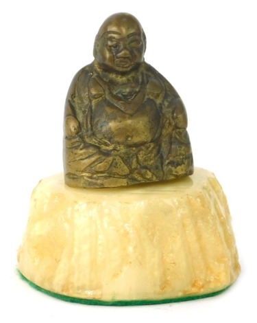 A brass Buddha paperweight, on an alabaster cream base, 12cm high.