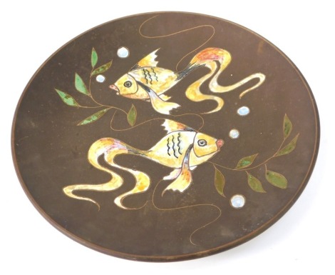 A German pottery charger, on a brown ground with painted fish, inscribed to reverse Schleierfisch, 717-3, 36cm diameter.