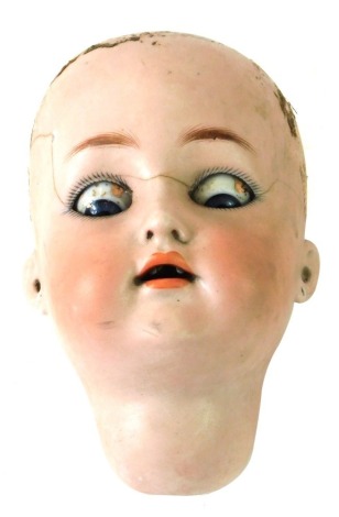 A Simon & Halbeig bisque dolls head, with blue glass roll eyes, No 62, K R, 14cm high. (AF)