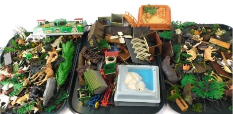 A group of plastic animals, fencing, agricultural vehicles, tin plate bus station, etc, Britains and others, play worn. (a quantity)